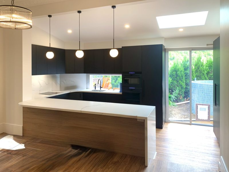 A comfortable, modern family kitchen, opening onto a dining space in the original 1920s California Bungalow.