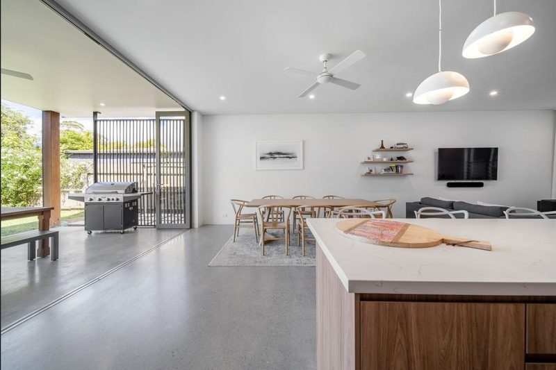Kitchen connects to dining spaces and views to the garden