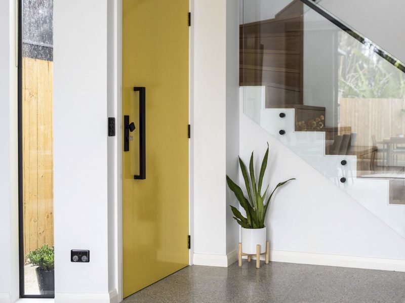 The new side entry, marked by a tall, bright yellow door: a celebration of the point of arrival, and a bit of fun.