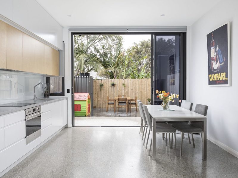 A galley kitchen makes the most of the limited space and opens onto a compact courtyard, perfect for entertaining and for the kids to play in.
