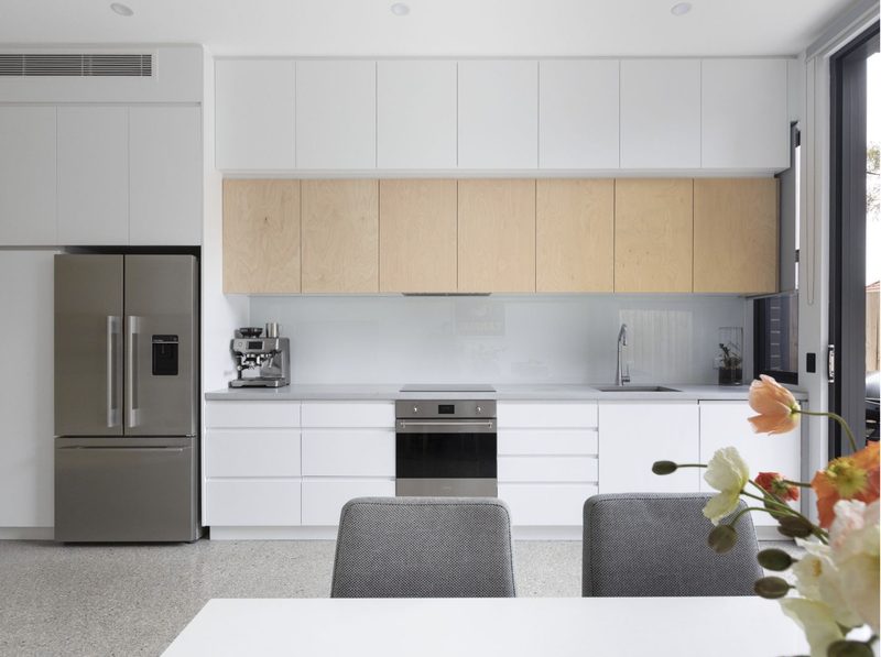 The galley kitchen is tucked against one wall to make the most of the space. A limited palette of materials keeps it contemporary, without visual clutter.
