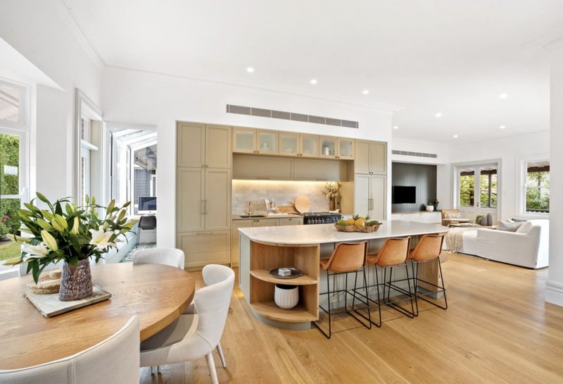 The kitchen is the heart of this gorgeous home in Mosman. Casual dining incorporates a Bay window, with the living room beside an adjoining balcony. The view through the doorway on the left is to the working kitchen and formal dining
