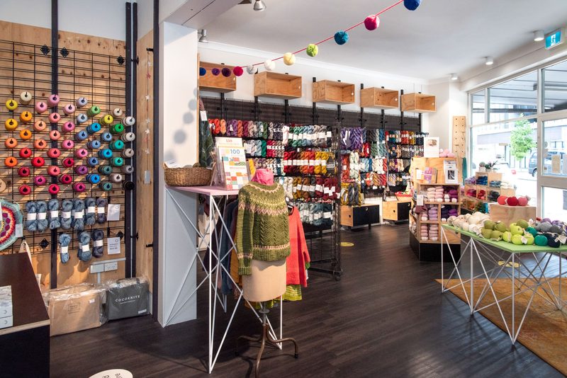 A colour palette of charcoal floors and walls, and pale timber, allows the colours of the yarn to shine. One of our challenges was finding ways to display the different shapes and forms that yarn comes in, while still maximising sales and allowing an easy flow for customers around the store.