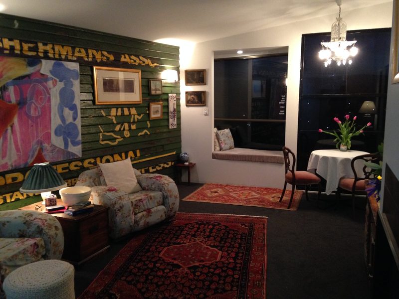 The bay window seat, the favourite spot, with the dining table set right at the tall floor-to-ceiling window. The green weatherboards were reclaimed from the Tasmanian Fishermen’s Association hut near the fishing wharf in Stanley, with their graphics still in place. The arrangement is almost an art piece in itself, in the spirit of Rosalie Gascoigne: recycled materials reused in an interesting way, instead of the sea of plasterboard in so many buildings.