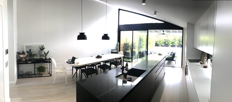 A tonal colour scheme, simple forms and pendant lighting define the dining space and make it more intimate in a space with tall ceilings. What was once a series of small disconnected spaces has now opened up into a warm generous space.