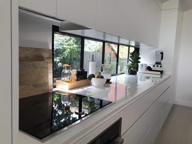 Bringing light and views of the garden into the kitchen, a window also acts as a splashback